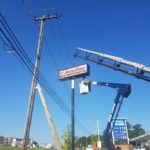 Autozone Illuminated Pylon Sign Installation with a crane and bucket truck in Maryland