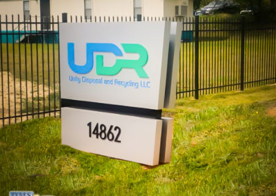 Isometric view. Illuminated Monument sign that reads UDR Unity Disposal and Recycling LLC