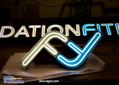 Exposed neon channel letter Foundation Fitness while being tested at DMS signs shop.