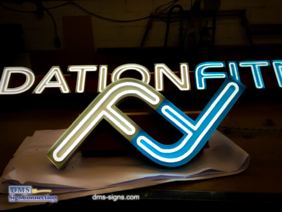 Exposed neon channel letter Foundation Fitness while being tested at DMS signs shop.